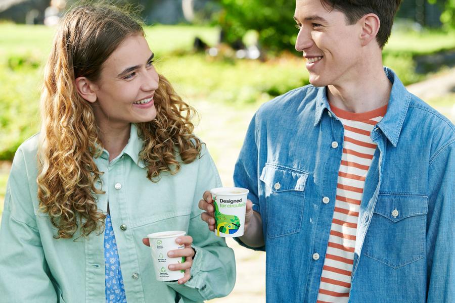 Couple with coffee cups made from renewable materials.