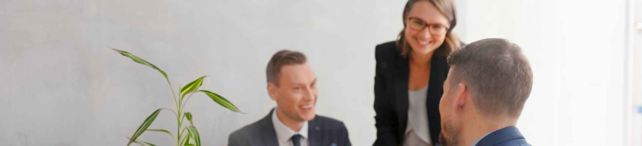A photo of 3 colleagues in an office