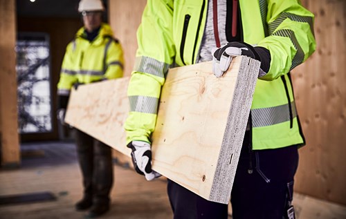 Builders carrying LVL board.