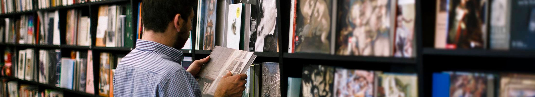 Man looking at books