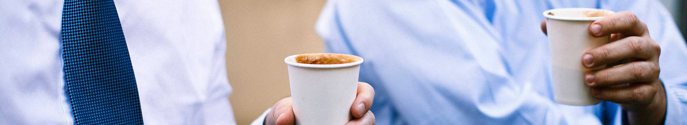 Men holding paper cups