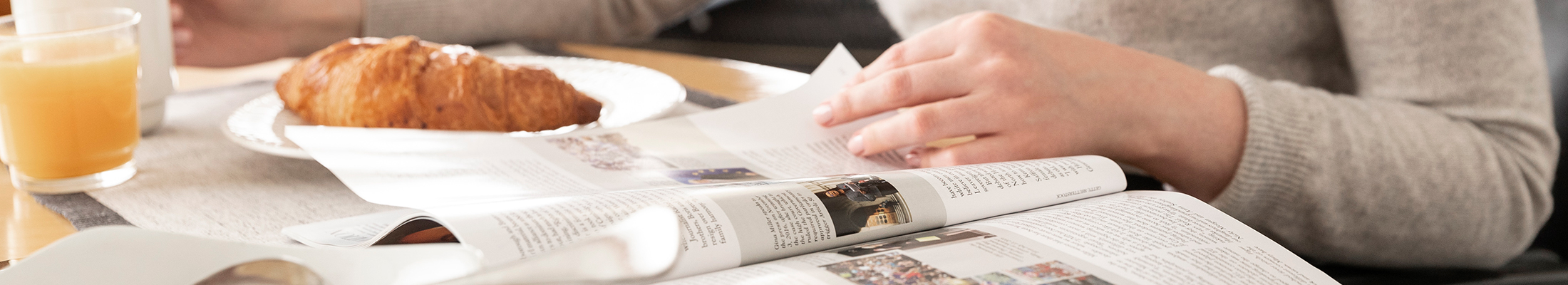 Reading a magazine at breakfast