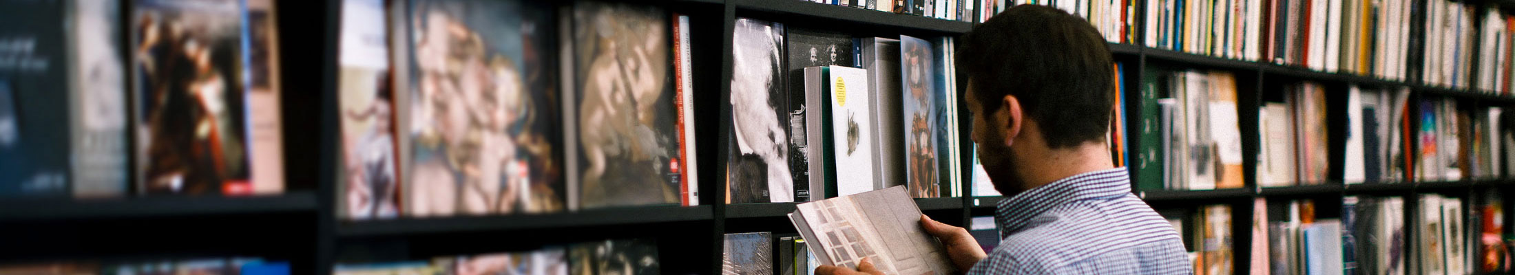 man reading in a bookstore
