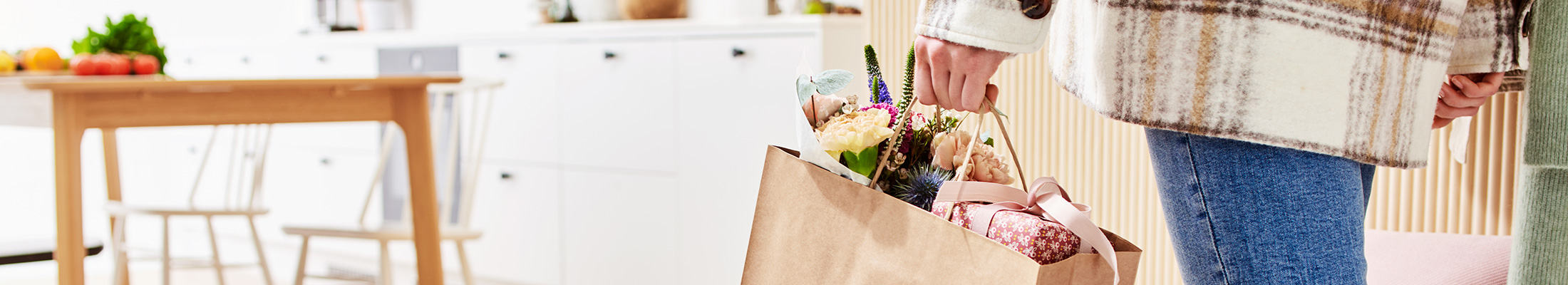 Woman carrying CarrEco Brown paper bag