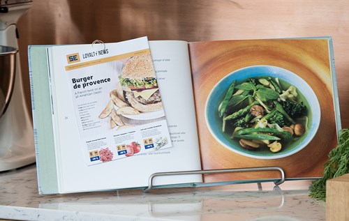 Hard cover cookery book opened in kitchen